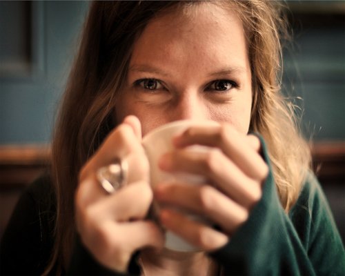 Relaxed man drinking water and smiling